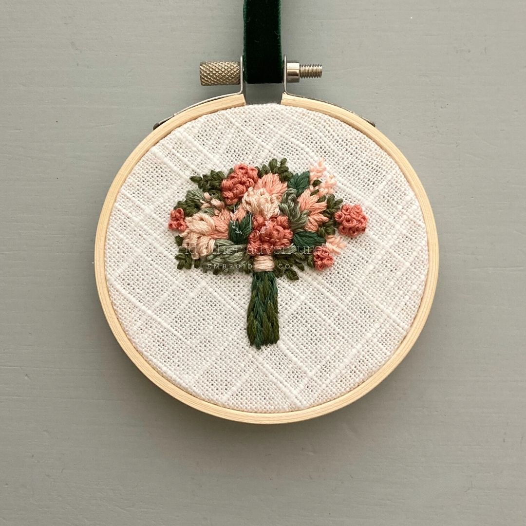 Hand embroidered bouquet featuring terracotta, ivory and sage flowers set againt the dark green leaves - Hand Stitched by And Other Adventures Embroidery Co