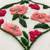 Hand Embroidered Floral details in pink and green color palette by And Other Adventures Embroidery Co