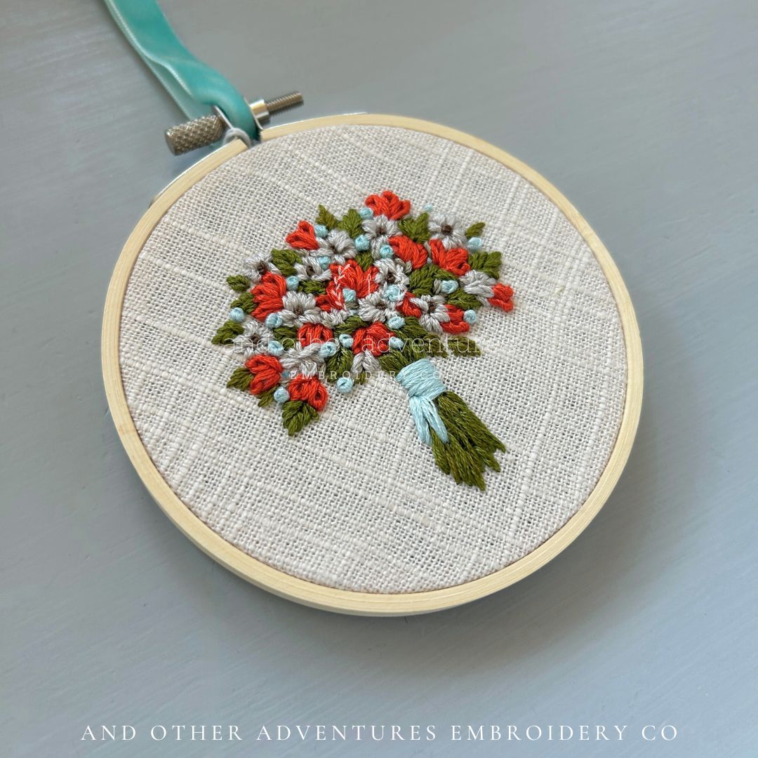 Hand Embroidered Florals inspired by the colors of Life of a Showgirl album cover - hand stitched by And Other Adventures Embroidery Co