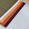 Fabric swatches in various dark academia colors arranged in a row on a light background.