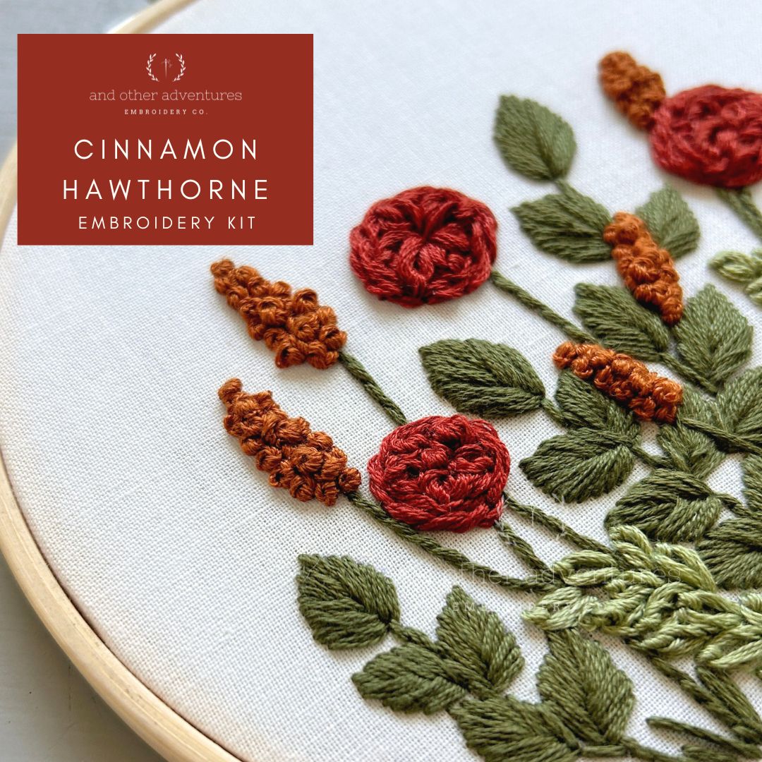 Embroidery kit with rust, green, and mustard flowers and leaves on a white fabric background - designed and sold by And Other Adventures Embroidery Co