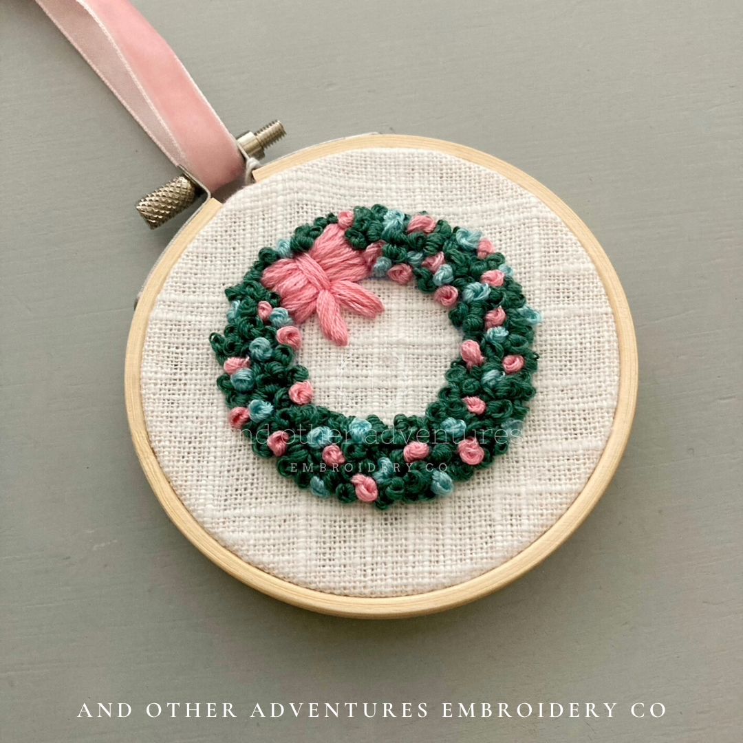 Baby blue and pink hand embroidered wreath ornament by And Other Adventures Embroidery Co