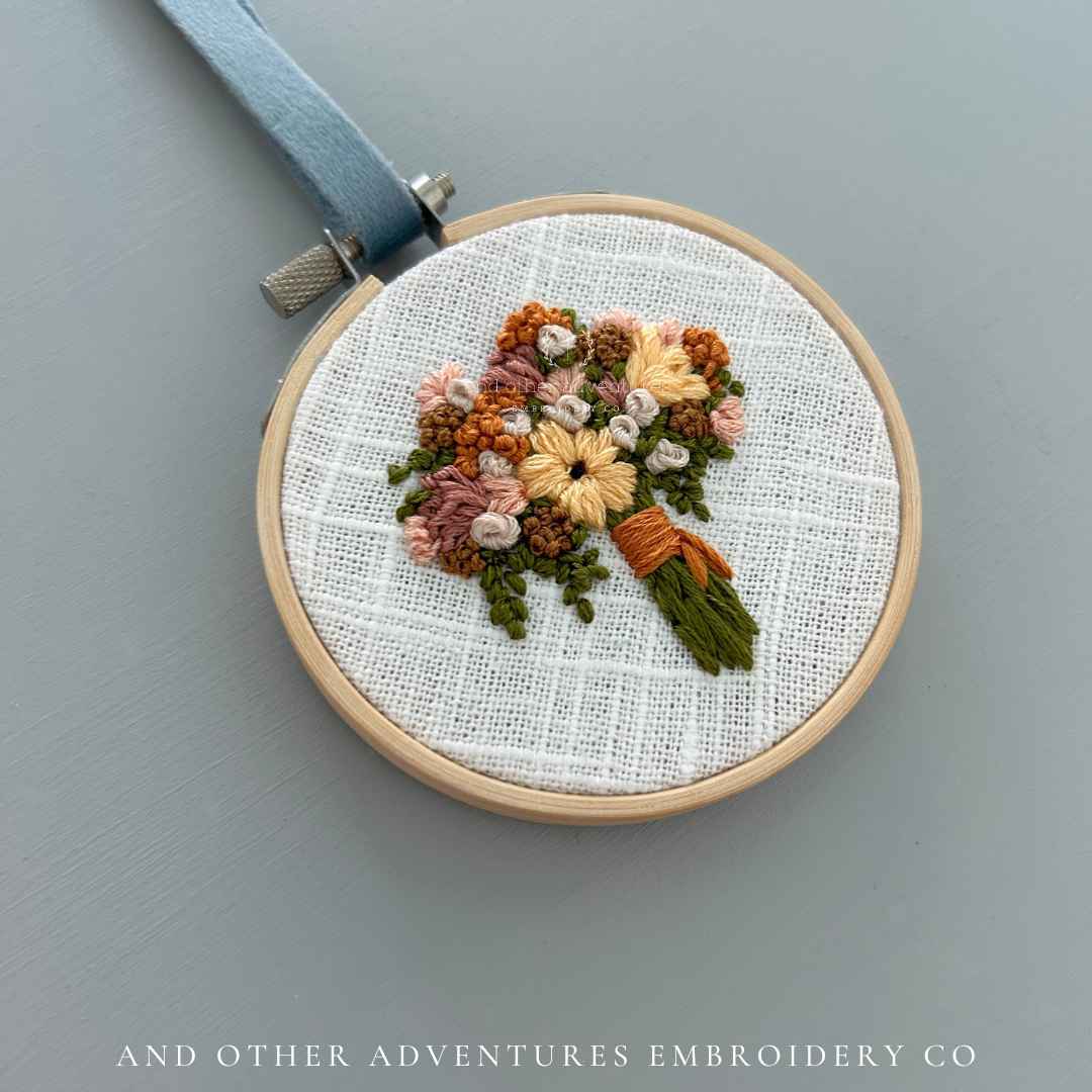 Orange and Yellow hand embroidered bouquet art - stitched by Colleen , the artist behind And Other Adventures Embroidery Co