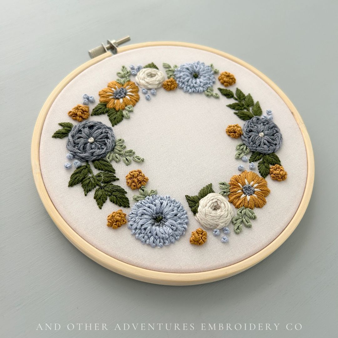 Hand embroidery kit featuring steel grey, blue, mustard and ivory florals in wreath - created and sold by And Other Adventures Embroidery Co