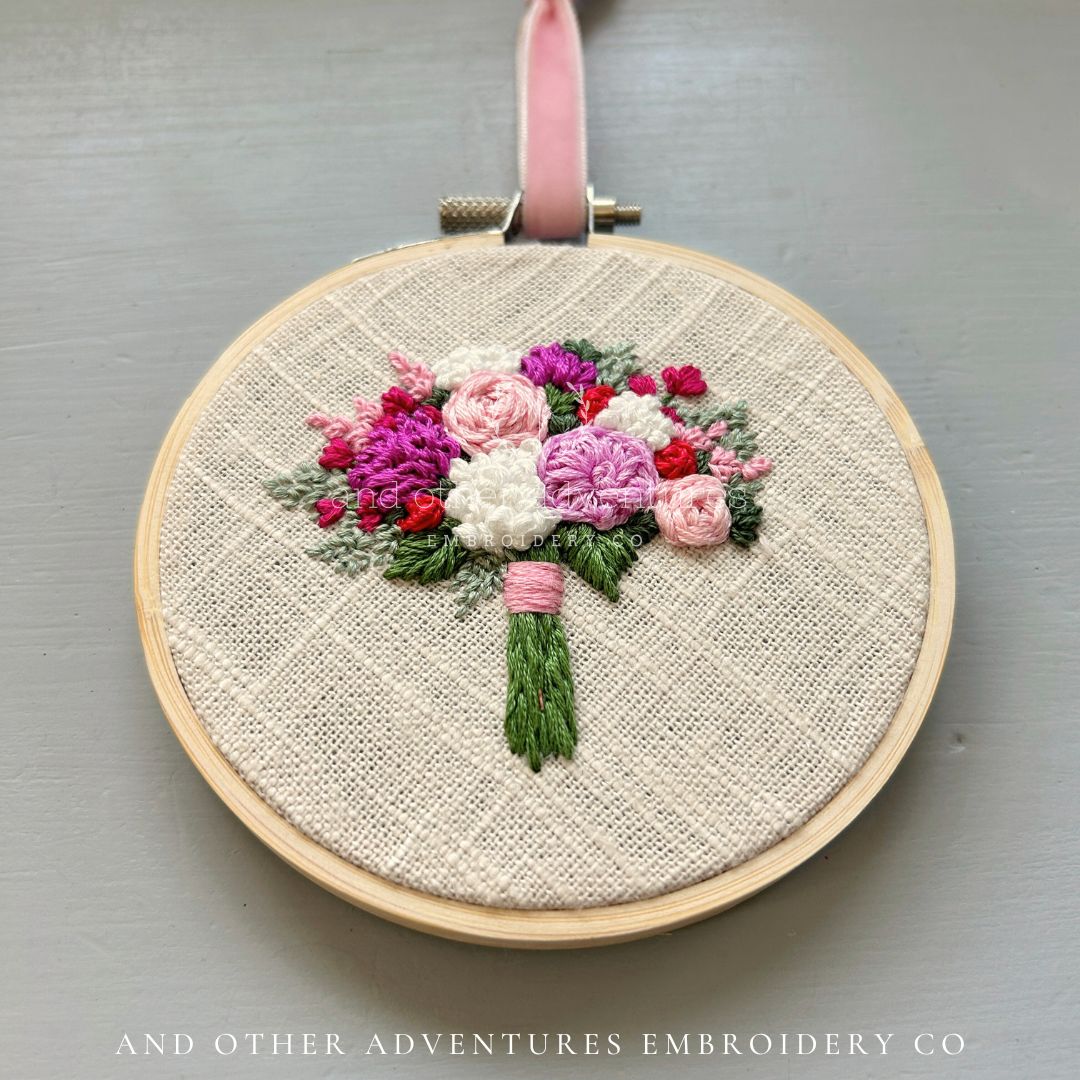 Hand embroidered bright bouquet in shades of pink, white, and greens - hand stitched by And Other Adventures Embroidery Co