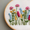 Hand Embroidered Pink, Blue, and Yellow flowers DIY embroidery by And Other Adventures Embroidery Co