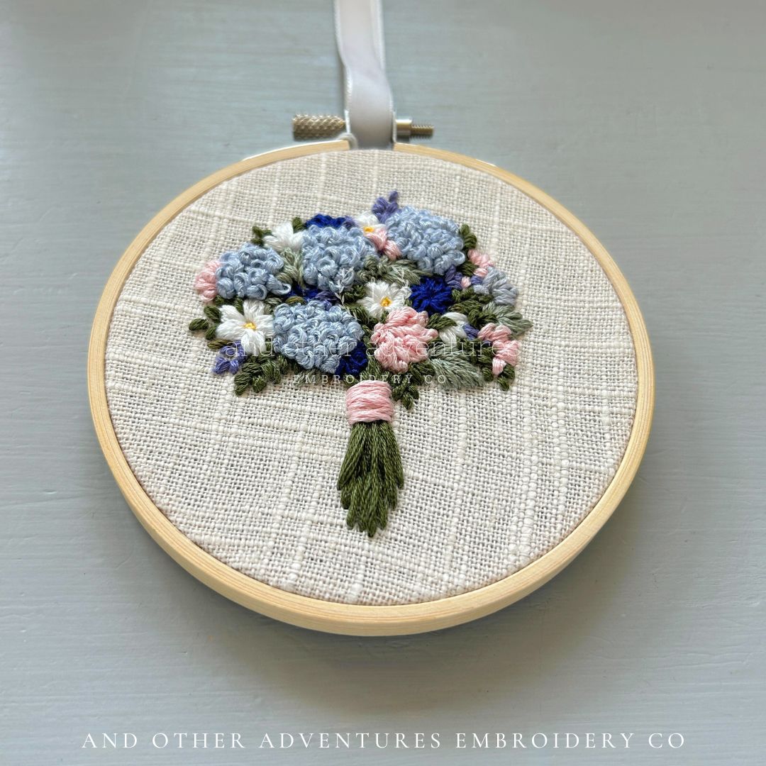 Blue hydrangea bouquet with pink dahlias and white daisies hand embroidered art by And Other Adventures Embroidery Co