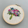 Whimsical bright flower bouquet hoop art hand embroidered by And Other Adventures Embroidery Co