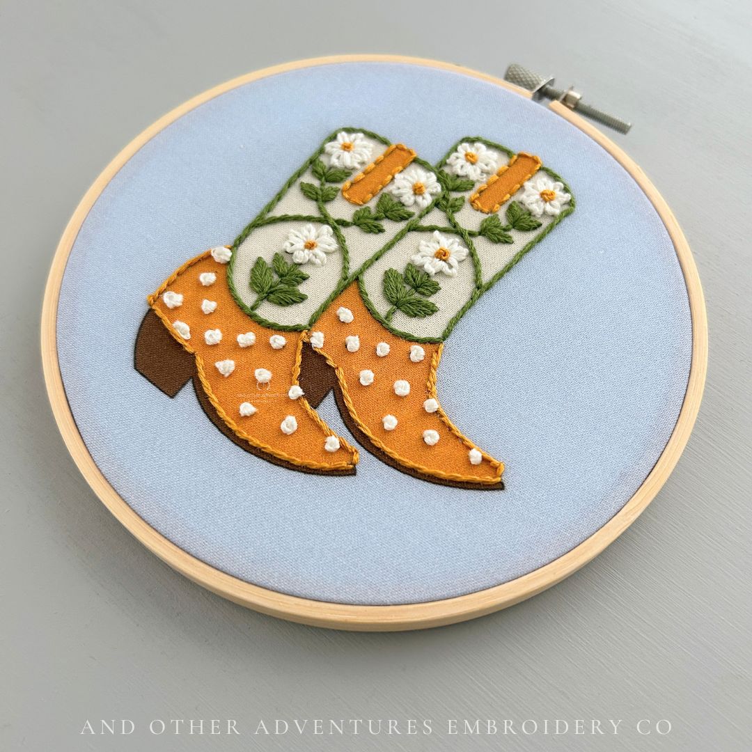 DIY beginner embroidery project featuring white daisy cowgirl boots by And Other Adventures Embroidery Co