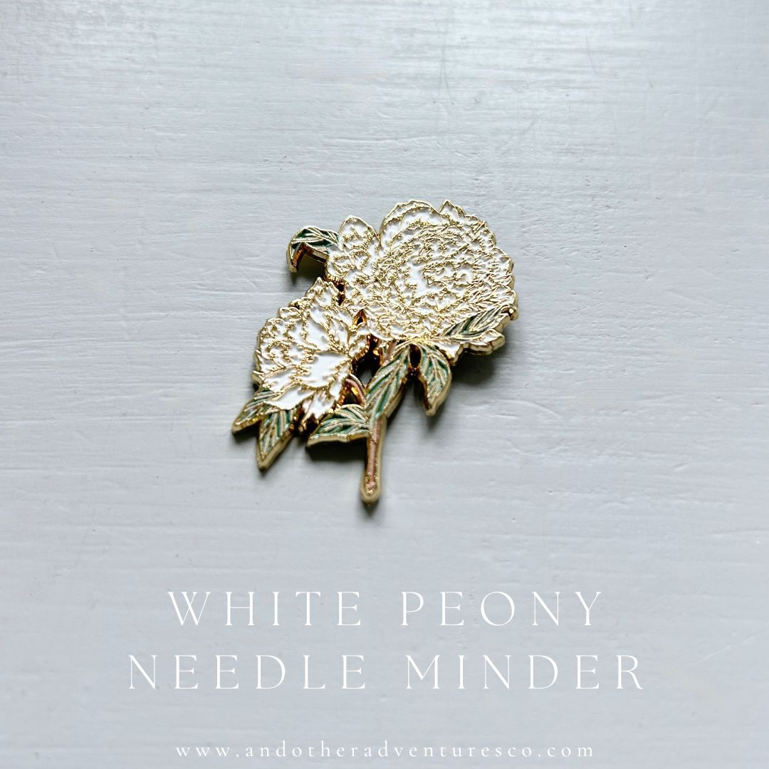 Gold enamel white peony needle minder 