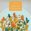 Hand embroidery kit with floral design and &#39;Winslow in Marigold&#39; text on a yellow label.