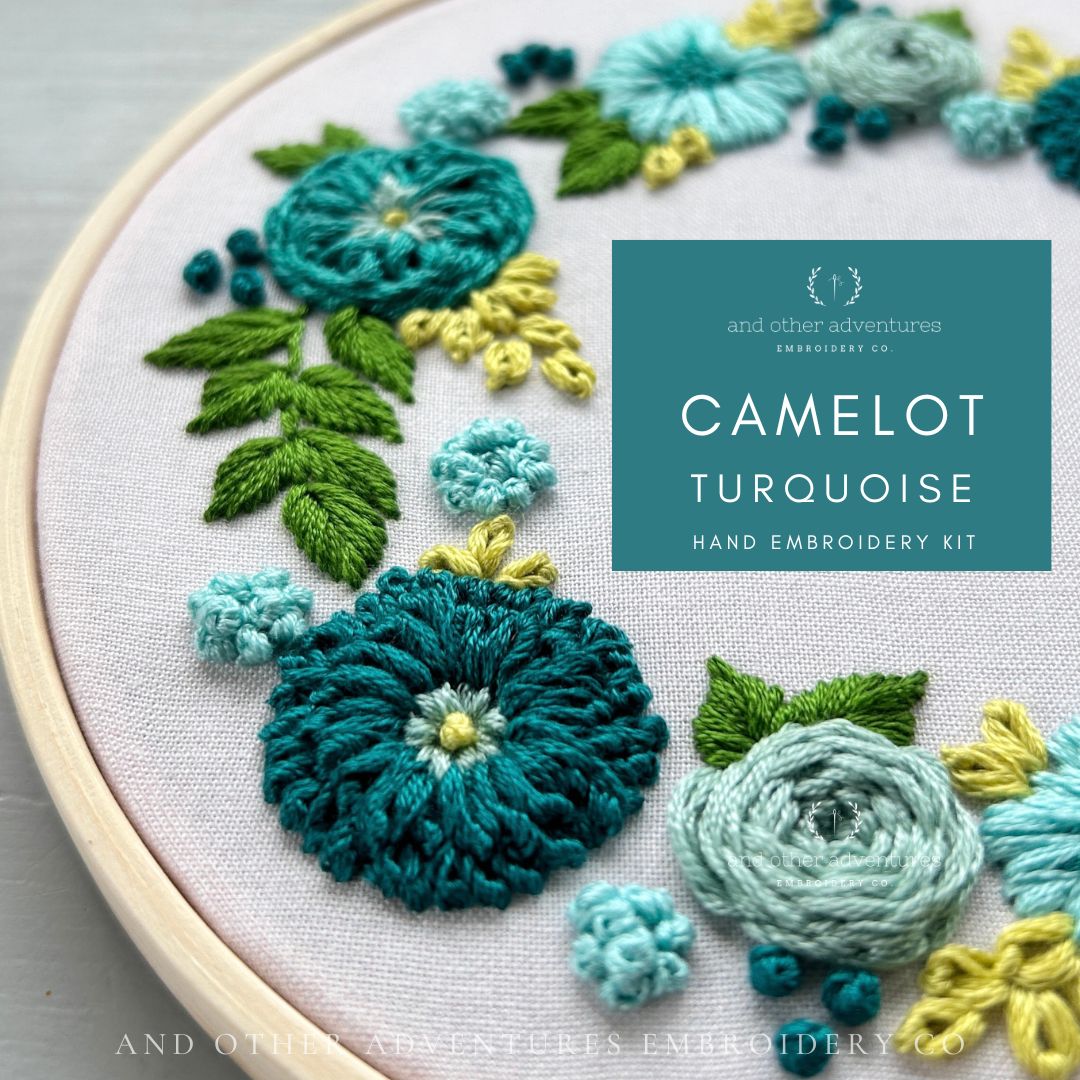 Embroidery hoop with floral embroidery design and 'Camelot Turquoise' kit label.