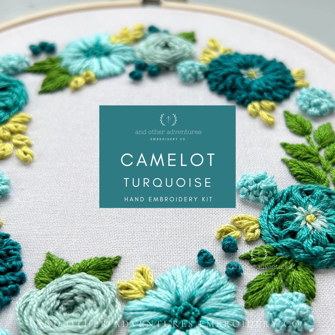 Embroidery hoop with floral pattern and 'Camelot Turquoise' hand embroidery kit label.