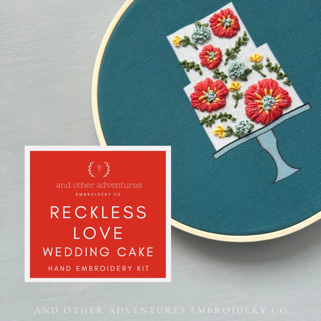 Hand embroidery kit with floral design on teal fabric, featuring 'Reckless Love Wedding Cake' by And Other Adventures Embroidery Co.