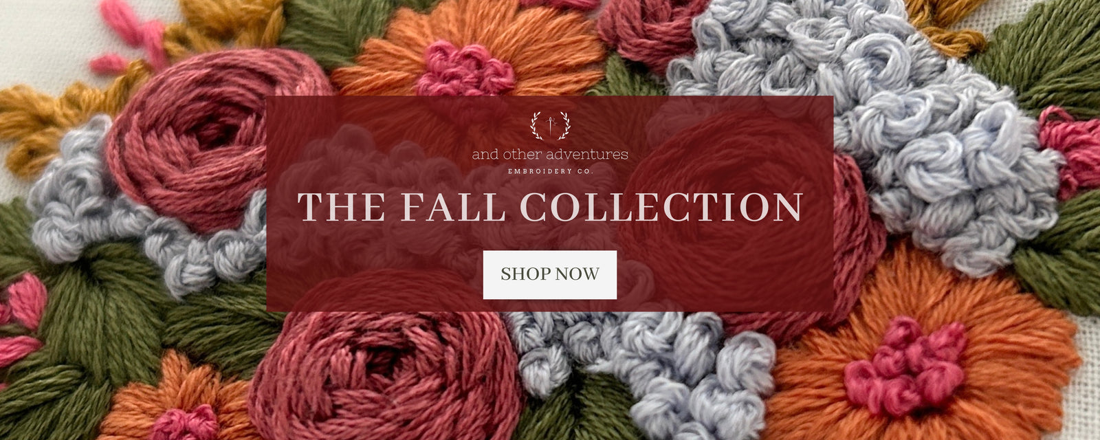 A promotional banner for 'The Fall Collection' featuring a central dark red translucent rectangle with white text over a background of colorful embroidered floral design in rust orange, dusty pink, sage green, and light gray - And Other Adventures Embroidery Co