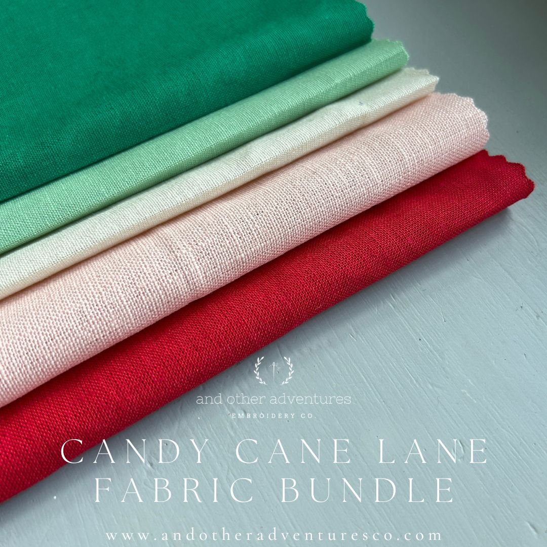 Stack of colorful holiday linen fabric swatches curated by And Other Adventures Embroidery Co