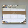 Weekly notepad with floral design on a plain background