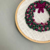 Hand Embroidered Wreath Ornament in shades of mauve, fuschia and green by And Other Adventures Embroidery Co