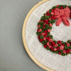 Hand Stitched Ornament Christmas Wreath in shades of red, pink and green by And Other Adventures Embroidery Co