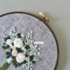 Hand stitched spring flower bouquet hoop art by And Other Adventures Embroidery Co